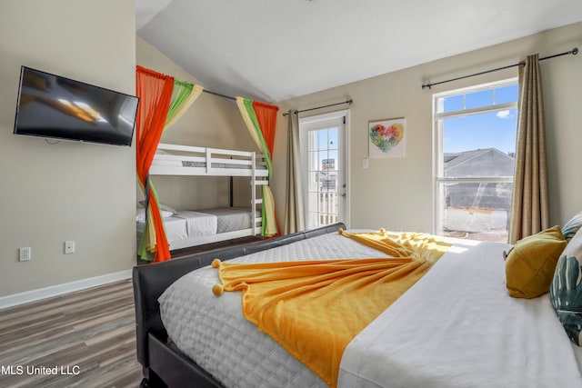 bedroom with hardwood / wood-style flooring and vaulted ceiling