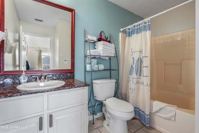 full bathroom with vanity, shower / bath combo, toilet, and tile patterned floors