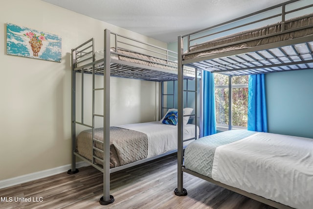 bedroom with hardwood / wood-style flooring