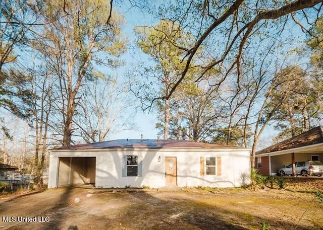 ranch-style house featuring driveway and a carport