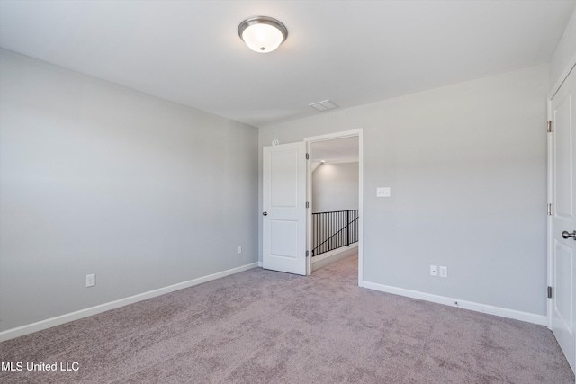 unfurnished bedroom with carpet, visible vents, and baseboards