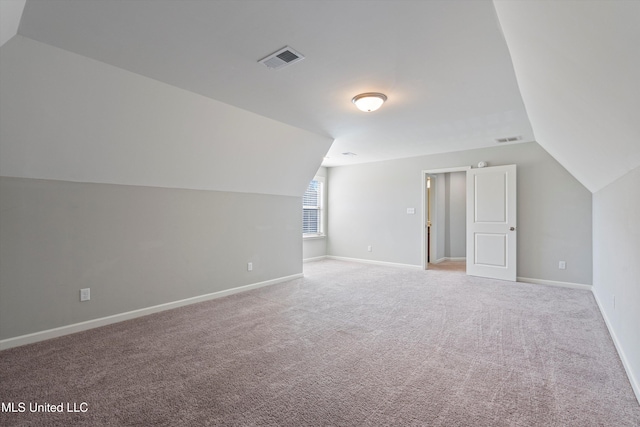 bonus room with vaulted ceiling, visible vents, and baseboards