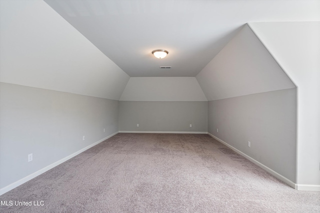 bonus room with lofted ceiling, carpet, visible vents, and baseboards