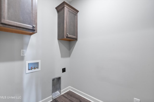 laundry area with cabinet space, baseboards, dark wood-style flooring, hookup for an electric dryer, and washer hookup