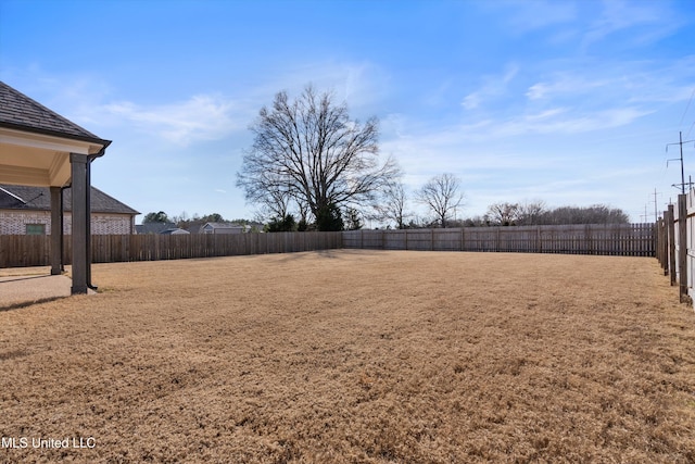 view of yard with a fenced backyard