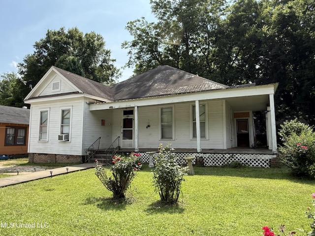 1057 Adams St, Grenada, MS 38901 - view of front facade with covered porch, a front lawn, and cooling unit