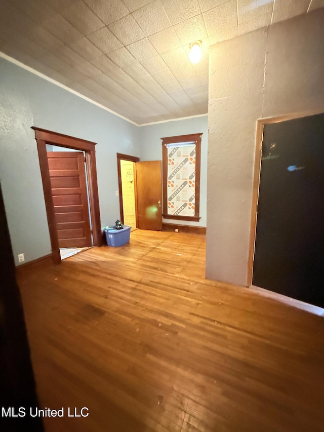 1057 Adams St, Grenada, MS 38901 - empty room with wood finished floors and ornamental molding