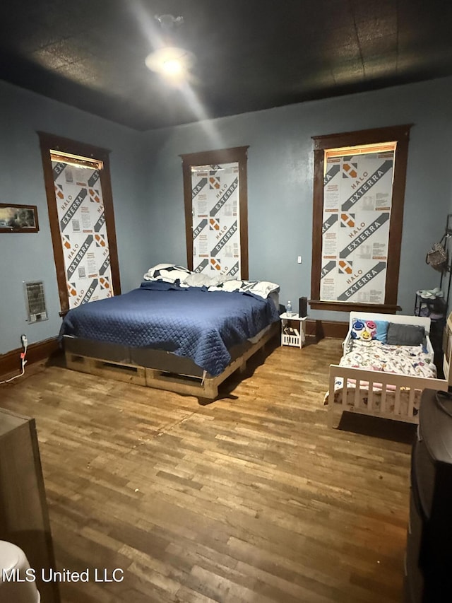 1057 Adams St, Grenada, MS 38901 - bedroom with wood finished floors and baseboards