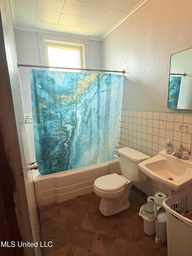 1057 Adams St, Grenada, MS 38901 - full bath featuring tile walls, a sink, shower / tub combo with curtain, toilet, and tile patterned flooring