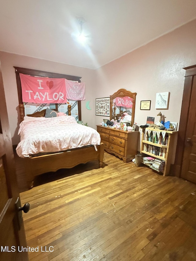 1057 Adams St, Grenada, MS 38901 - bedroom with wood-type flooring and lofted ceiling