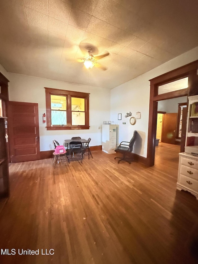 1057 Adams St, Grenada, MS 38901 - dining room with a ceiling fan, wood finished floors, and baseboards