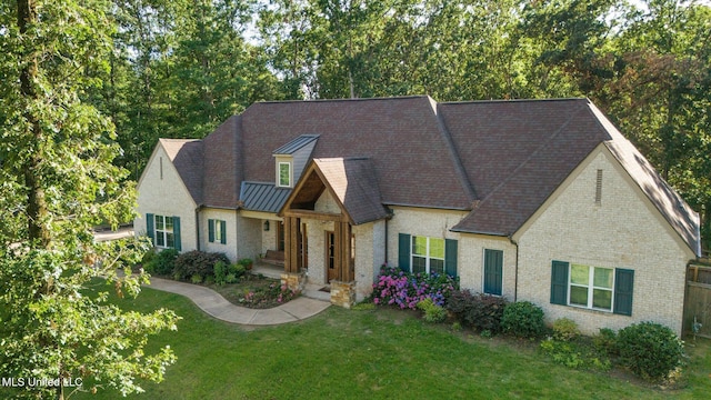 1075 S Laughter Rd, Hernando, MS 38632 - view of front facade with brick siding, a front lawn, and a standing seam roof