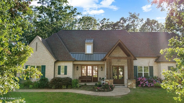 1075 S Laughter Rd, Hernando, MS 38632 - view of front of house featuring brick siding, a front yard, a standing seam roof, and metal roof