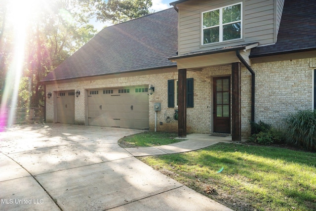 1075 S Laughter Rd, Hernando, MS 38632 - view of front facade with an attached garage, roof with shingles, concrete driveway, and brick siding