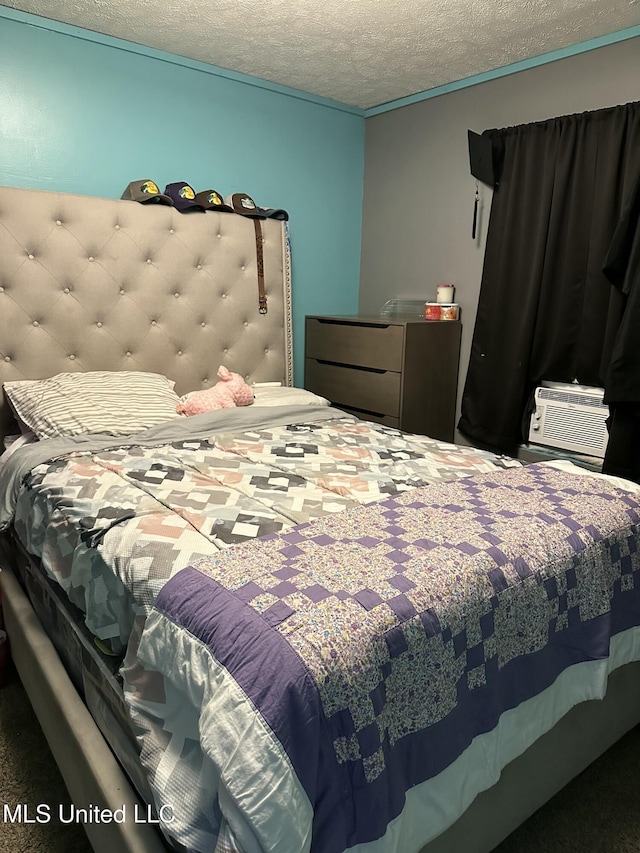 bedroom featuring cooling unit and a textured ceiling