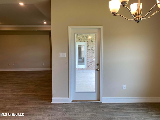 interior space with a notable chandelier and dark hardwood / wood-style floors