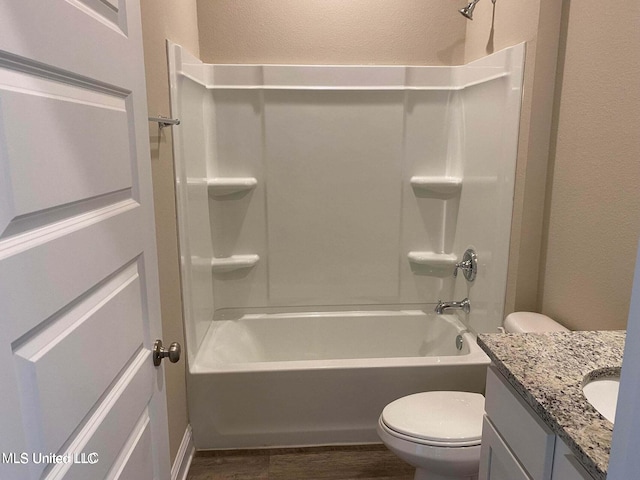 full bathroom featuring vanity, toilet, hardwood / wood-style floors, and shower / bathtub combination