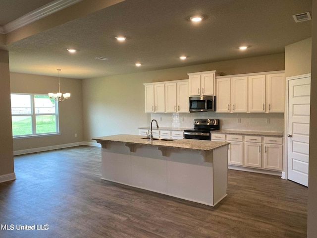 kitchen featuring white cabinets, a kitchen island with sink, stainless steel appliances, and sink