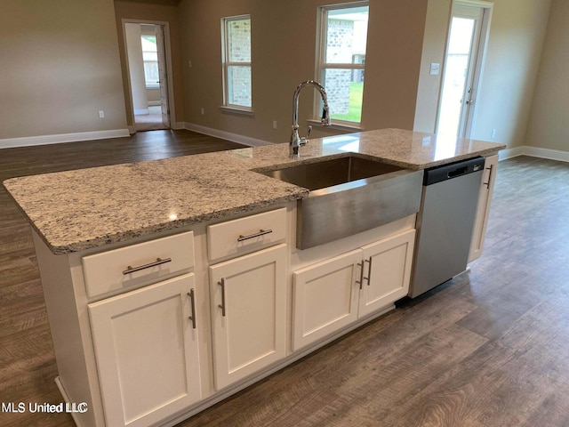 kitchen featuring light stone countertops, sink, stainless steel dishwasher, white cabinets, and dark hardwood / wood-style floors