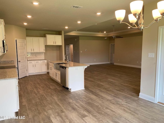 kitchen featuring light stone counters, appliances with stainless steel finishes, white cabinetry, a kitchen island with sink, and sink