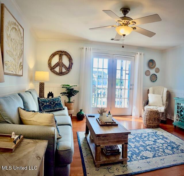 living room with ornamental molding, ceiling fan, and dark hardwood / wood-style flooring