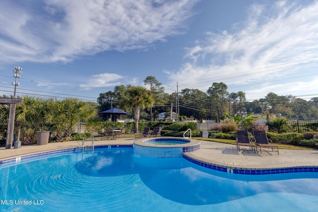 2421 Beachview Dr Unit B02, Ocean Springs, MS 39564 - view of swimming pool featuring a patio area, fence, and a pool with connected hot tub