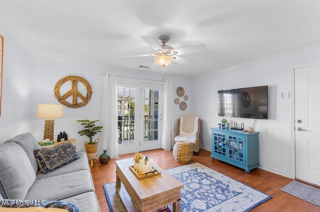 2421 Beachview Dr Unit B02, Ocean Springs, MS 39564 - living area featuring crown molding, ceiling fan, wood finished floors, and a wainscoted wall