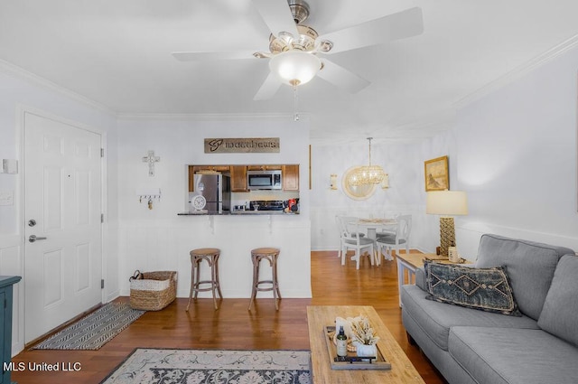 2421 Beachview Dr Unit B02, Ocean Springs, MS 39564 - living room featuring crown molding, a wainscoted wall, ceiling fan with notable chandelier, and wood finished floors
