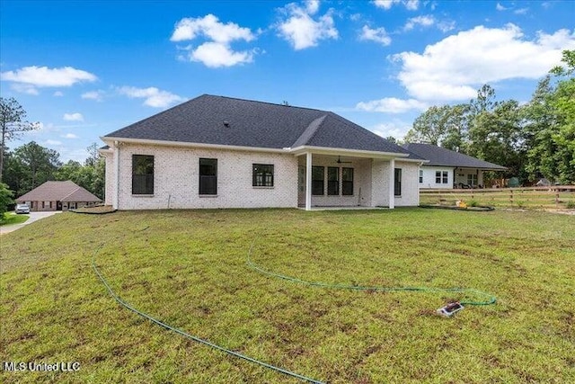 rear view of house with a lawn