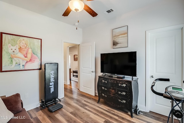 living room featuring hardwood / wood-style flooring and ceiling fan