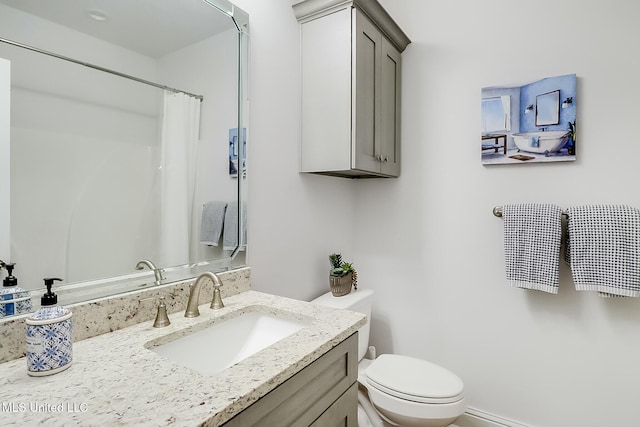 bathroom featuring vanity, toilet, and walk in shower