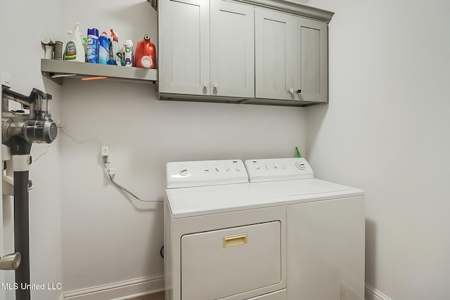 laundry room featuring cabinets and separate washer and dryer