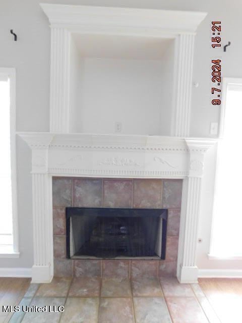 room details featuring a tile fireplace