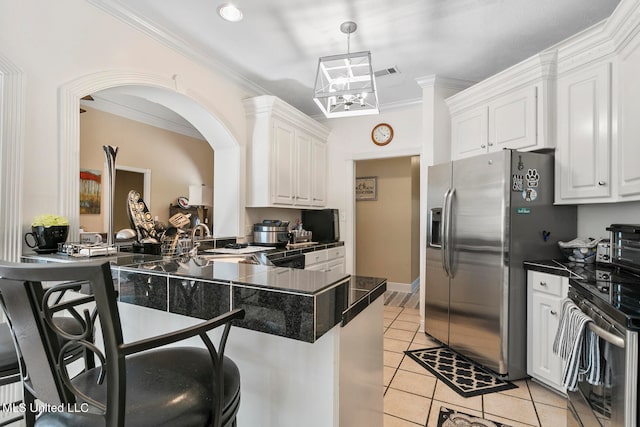 kitchen with kitchen peninsula, white cabinets, stainless steel appliances, and light tile patterned floors