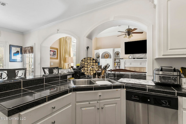 kitchen with a wealth of natural light, dishwasher, white cabinetry, and crown molding