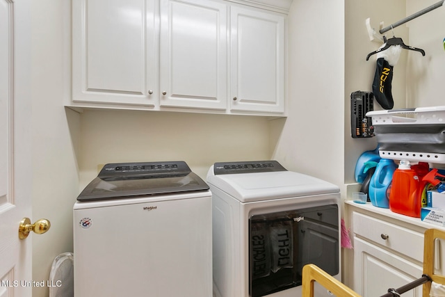 clothes washing area with independent washer and dryer and cabinets