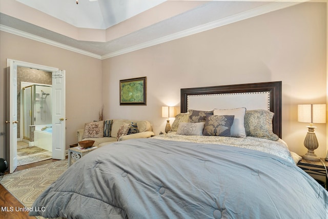 bedroom featuring crown molding, hardwood / wood-style flooring, and ensuite bathroom