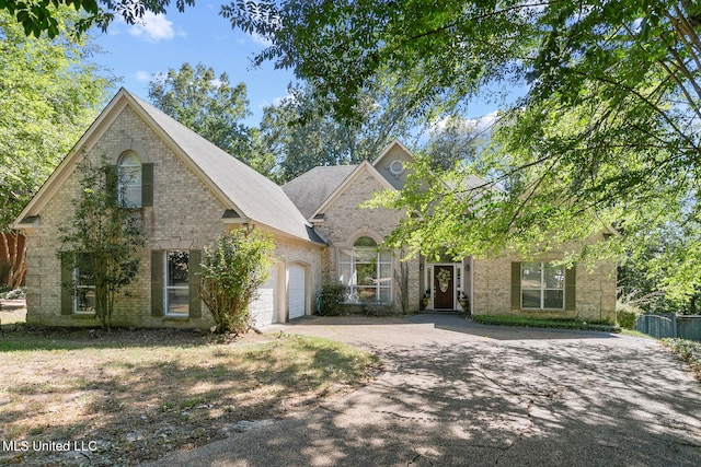 french country home with a garage