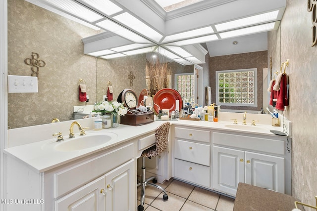 bathroom with vanity, ornamental molding, and tile patterned flooring