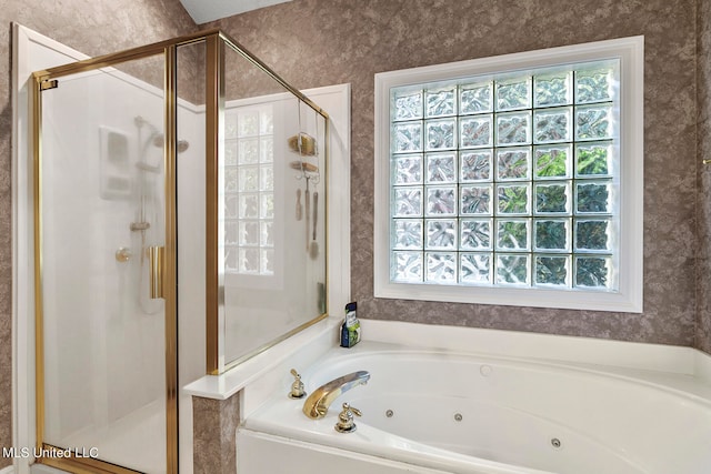 bathroom featuring a healthy amount of sunlight and separate shower and tub