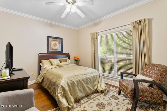 bedroom featuring ceiling fan, crown molding, a textured ceiling, and hardwood / wood-style floors