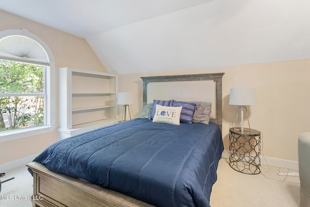 bedroom featuring lofted ceiling and light colored carpet