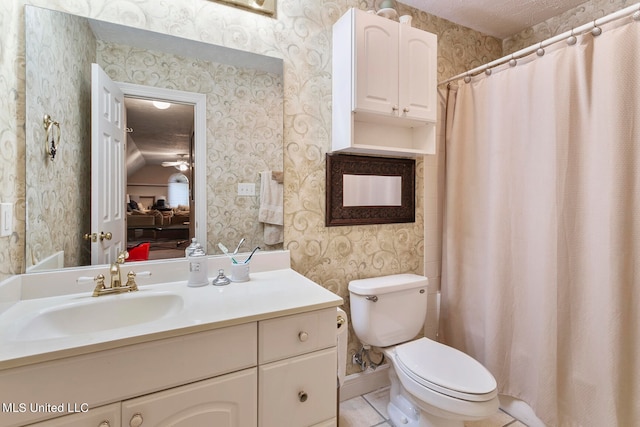 bathroom with toilet, ceiling fan, lofted ceiling, vanity, and tile patterned flooring