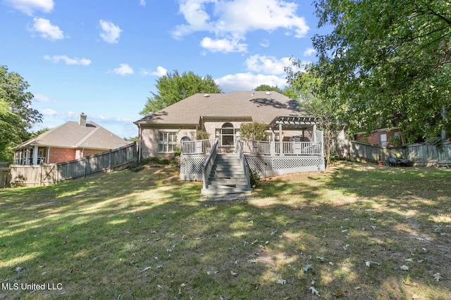 rear view of house with a pergola, a deck, and a yard