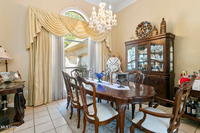 dining space featuring a notable chandelier, ornamental molding, and light tile patterned floors