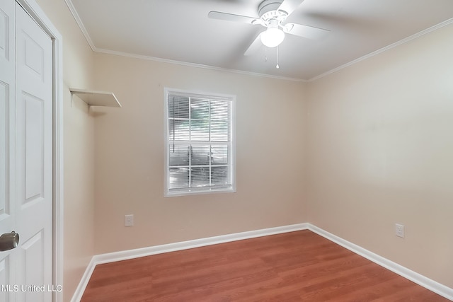 spare room featuring crown molding, wood-type flooring, and ceiling fan