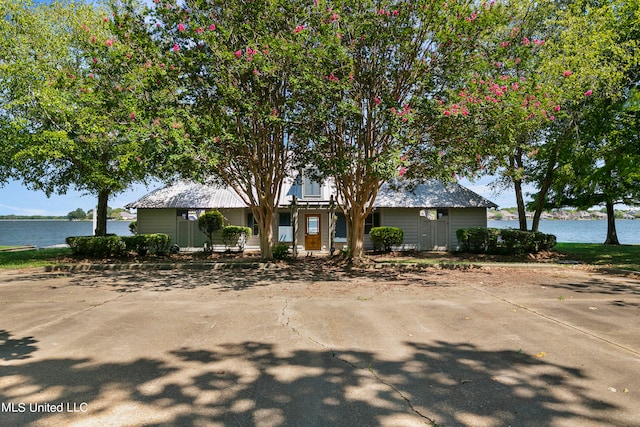 view of front of house with a water view