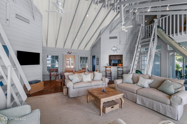 living room featuring hardwood / wood-style floors, rail lighting, high vaulted ceiling, and ceiling fan