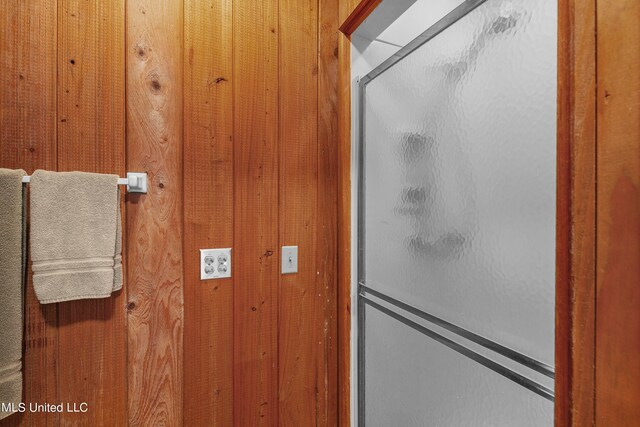 bathroom featuring wooden walls