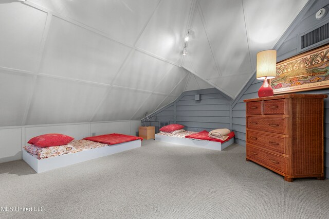 bedroom featuring carpet and vaulted ceiling